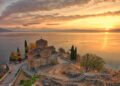 "Sunset view of the Church of Saint John at Kaneo perched on a cliff overlooking Lake Ohrid, reflecting the serene beauty of Macedonia's heritage."