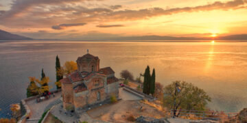 "Sunset view of the Church of Saint John at Kaneo perched on a cliff overlooking Lake Ohrid, reflecting the serene beauty of Macedonia's heritage."
