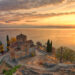 "Sunset view of the Church of Saint John at Kaneo perched on a cliff overlooking Lake Ohrid, reflecting the serene beauty of Macedonia's heritage."