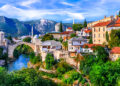 "A stunning view of Bosnia and Herzegovina's landscapes, featuring rolling hills, lush forests, and snow-capped mountains in the distance."