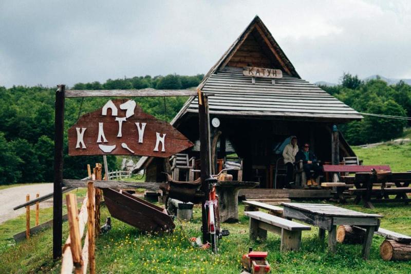 "Traditional stone houses and lush meadows at Etno Katun Durmitor, set against the backdrop of the majestic Durmitor mountains."