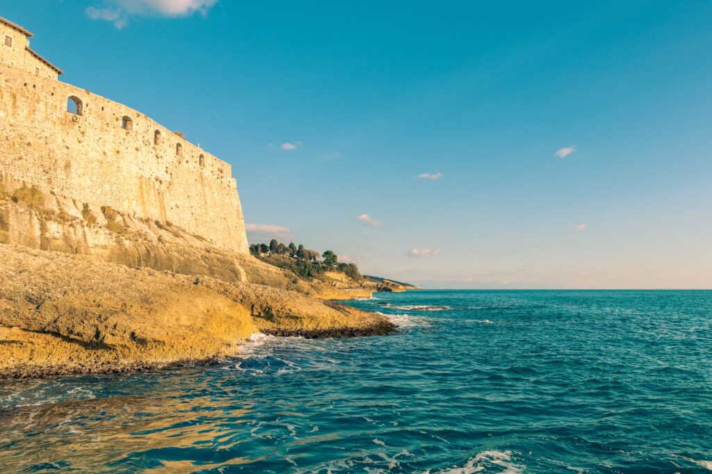 Adriatic Coast, Montenegro — Explore the historic Ulcinj fortress overlooking the stunning Adriatic coastline under a clear summer sky.