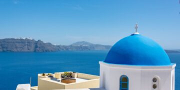 Aegean Islands, Greece — Iconic blue dome church in Santorini with a stunning view of the Aegean Sea.