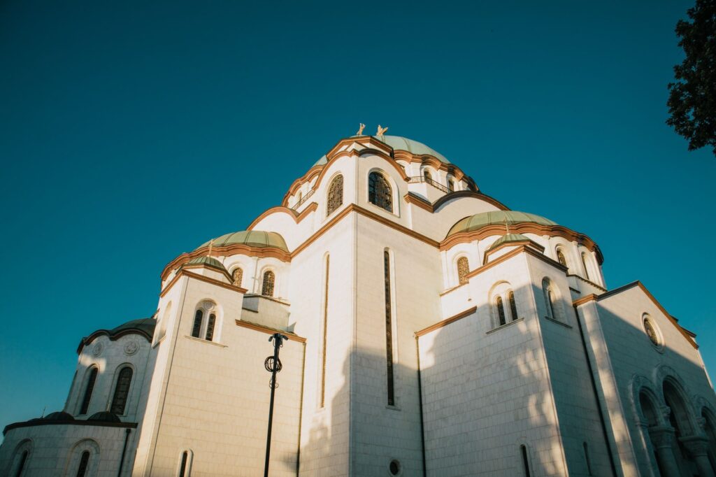 Belgrade, Serbia — Majestic view of the Saint Sava Temple's architecture with a vibrant blue sky backdrop.