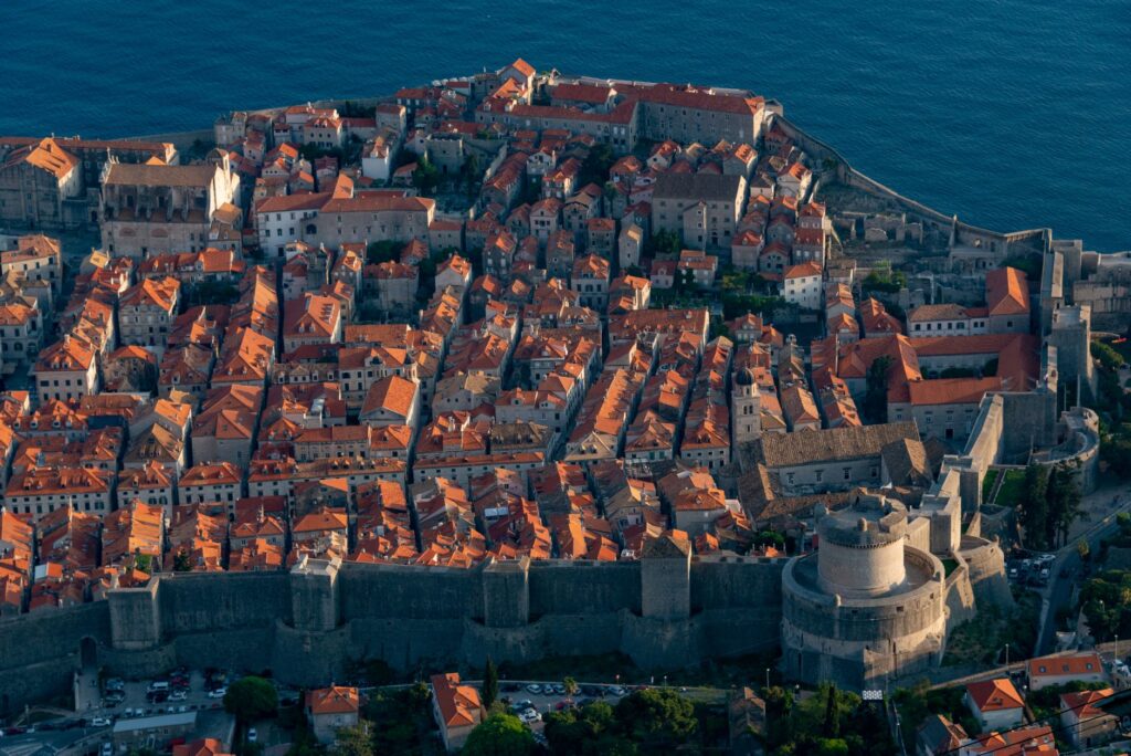 Dubrovnik, Croatia — Breathtaking aerial shot of Dubrovnik's historic Old Town, showcasing ancient city walls and red-tiled roofs.