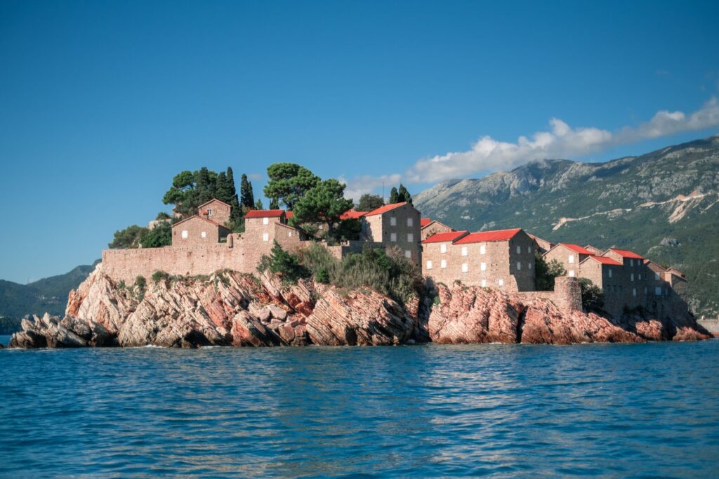 Igalo, Montenegro — Sveti Stefan, Montenegro, stunning island fortress with red-roofed buildings on the Adriatic Sea, framed by mountains.