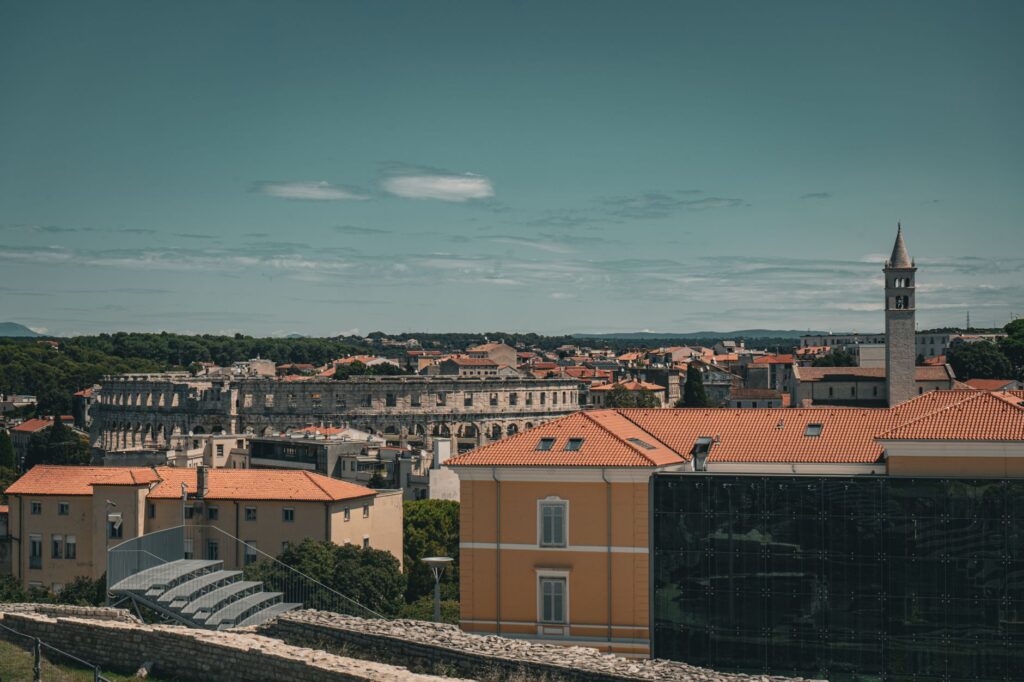 Istria, Croatia — A picturesque aerial view of Pula, Croatia, featuring the historic Roman amphitheater.