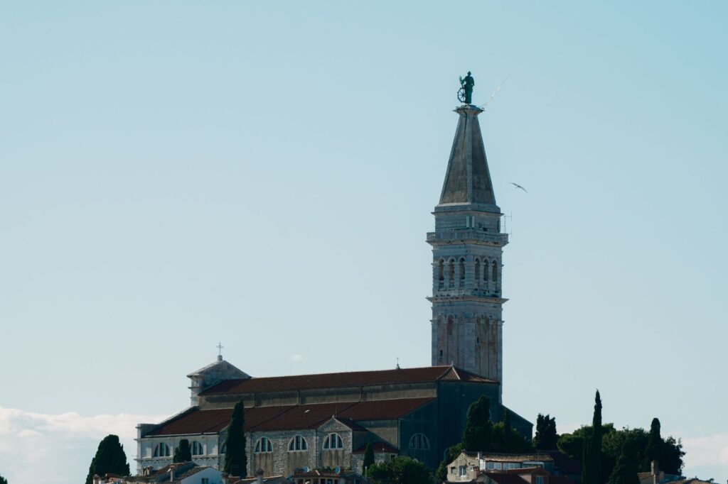 Istria, Croatia — A view of the iconic St. Euphemia Church in Rovinj, Croatia, highlighting its stunning architecture under a clear blue sky.
