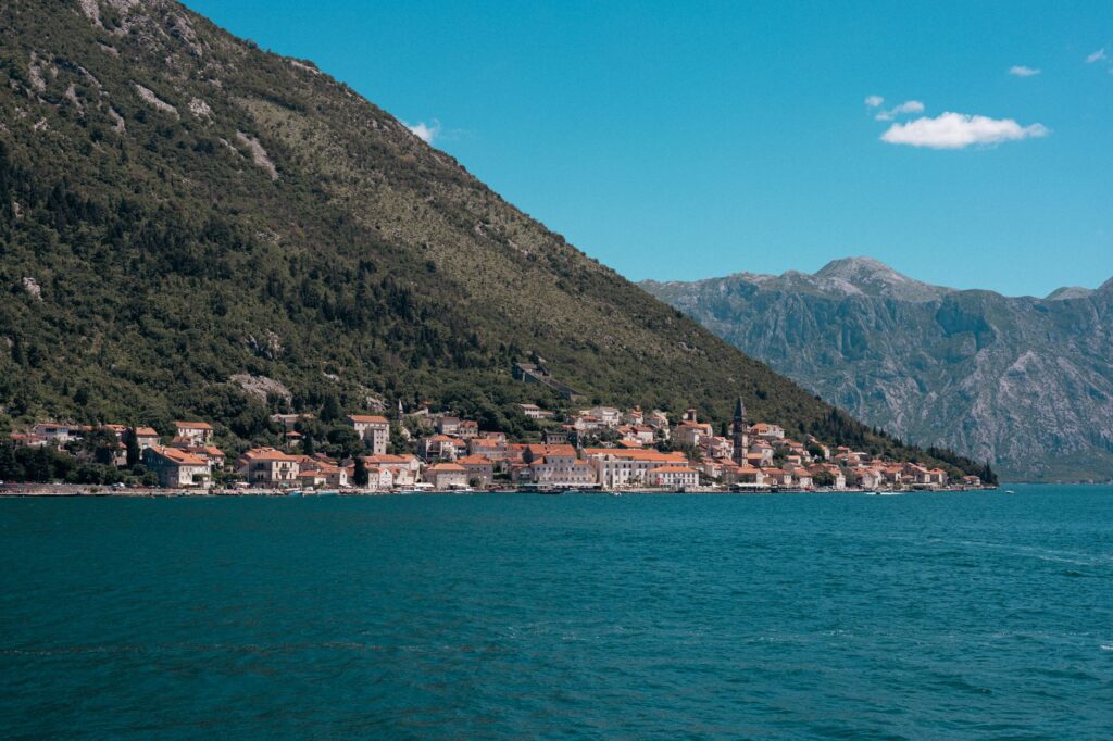 Kotor, Montenegro — Beautiful seaside town along the Bay of Kotor with mountains and clear blue water.