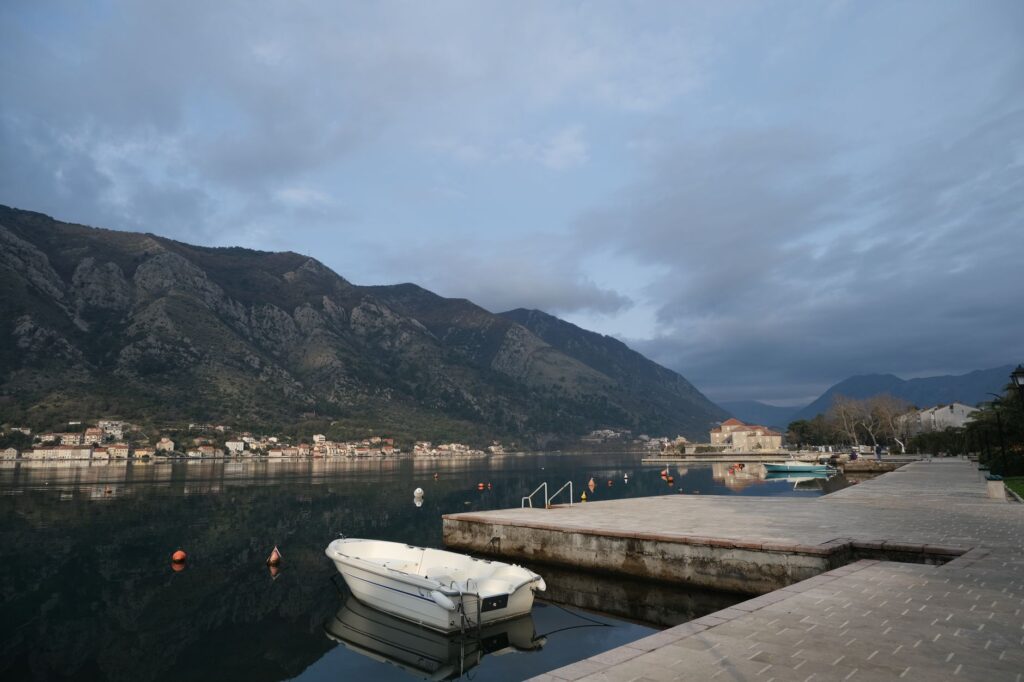 Kotor, Montenegro — Peaceful morning view of Kotor Bay in Montenegro, showcasing calm waters and mountainous backdrop.