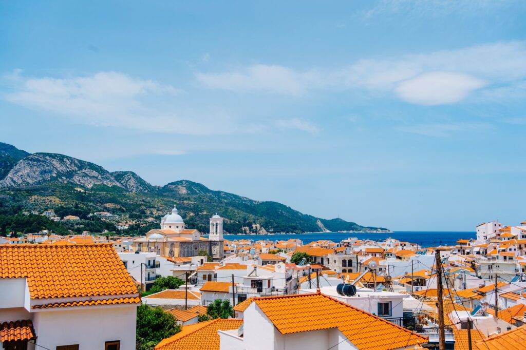 Laganas, Greece — Panoramic view of Kokkari village with orange roofs by the sea in Greece.