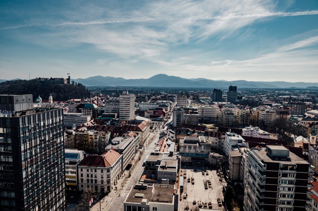 Ljubljana, Slovenia — A stunning aerial view of Ljubljana, Slovenia featuring the city's buildings, castle, and surrounding mountains.