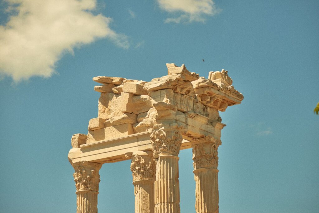 Loutraki, Greece — Explore the grandeur of ancient Roman architecture with this stunning image of majestic temple ruins against a bright blue sky.