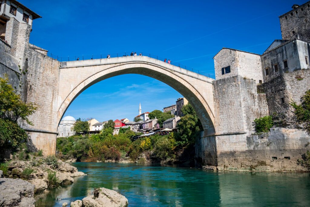 Mostar, Bosnia and Herzegovina — View of the historic Stari Most bridge in Mostar, Bosnia, under a clear blue sky.