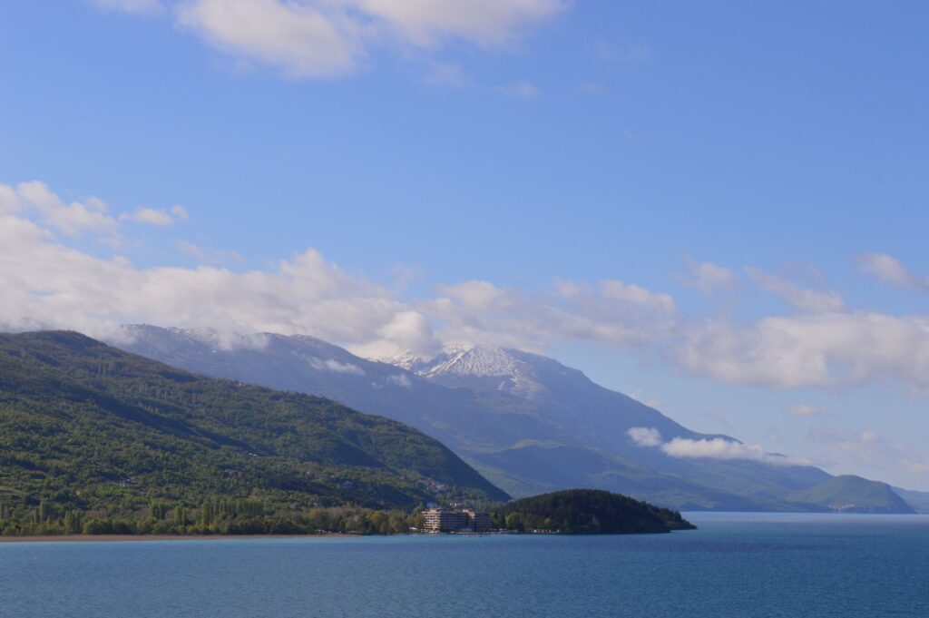 Ohrid, North Macedonia — Serene landscape of Lake Ohrid with mountains under a clear blue sky in North Macedonia.