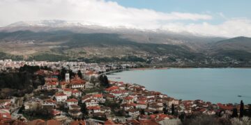 Ohrid, North Macedonia — Aerial shot of Ohrid town overlooking Lake Ohrid with mountains in the background, timeless beauty.