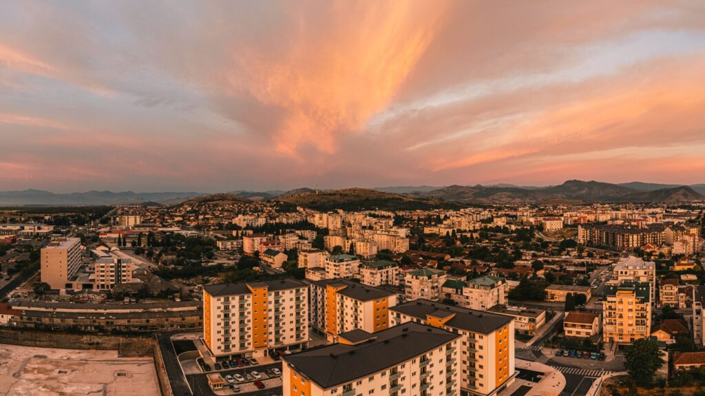 Podgorica, Montenegro — Scenic aerial view of Podgorica, Montenegro at sunset featuring vibrant skies and urban architecture.