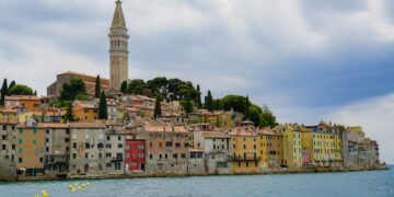 Rovinj, Croatia — Charming view of Rovinj's colorful waterfront and iconic bell tower on a cloudy day.
