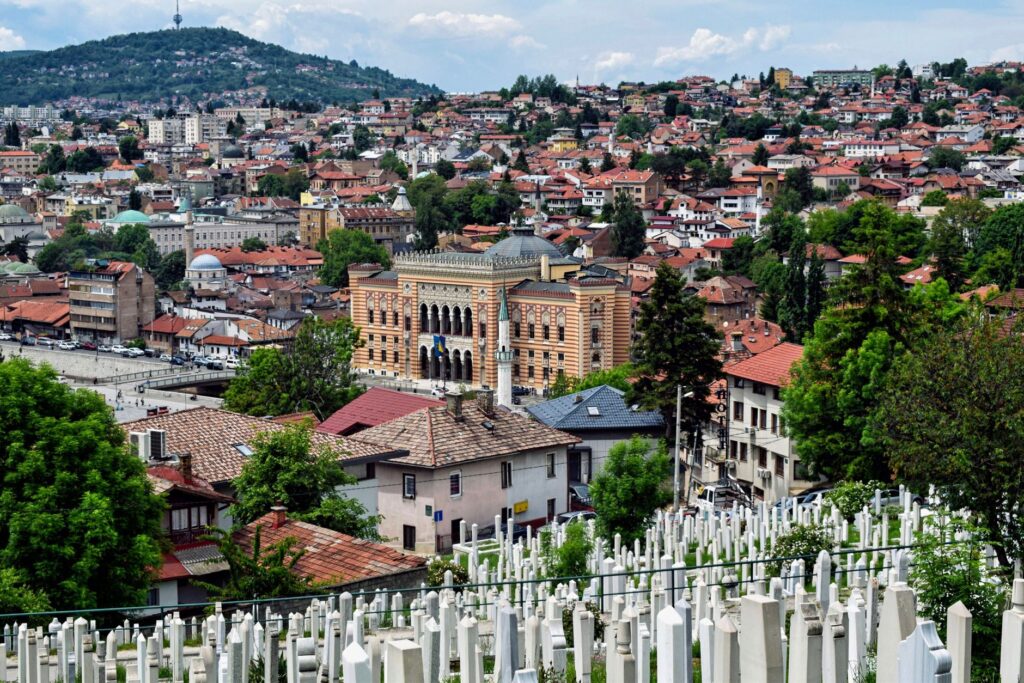 Sarajevo, Bosnia and Herzegovina — Explore Sarajevo's historic architecture with a panoramic city view framed by lush greenery and timeless charm.