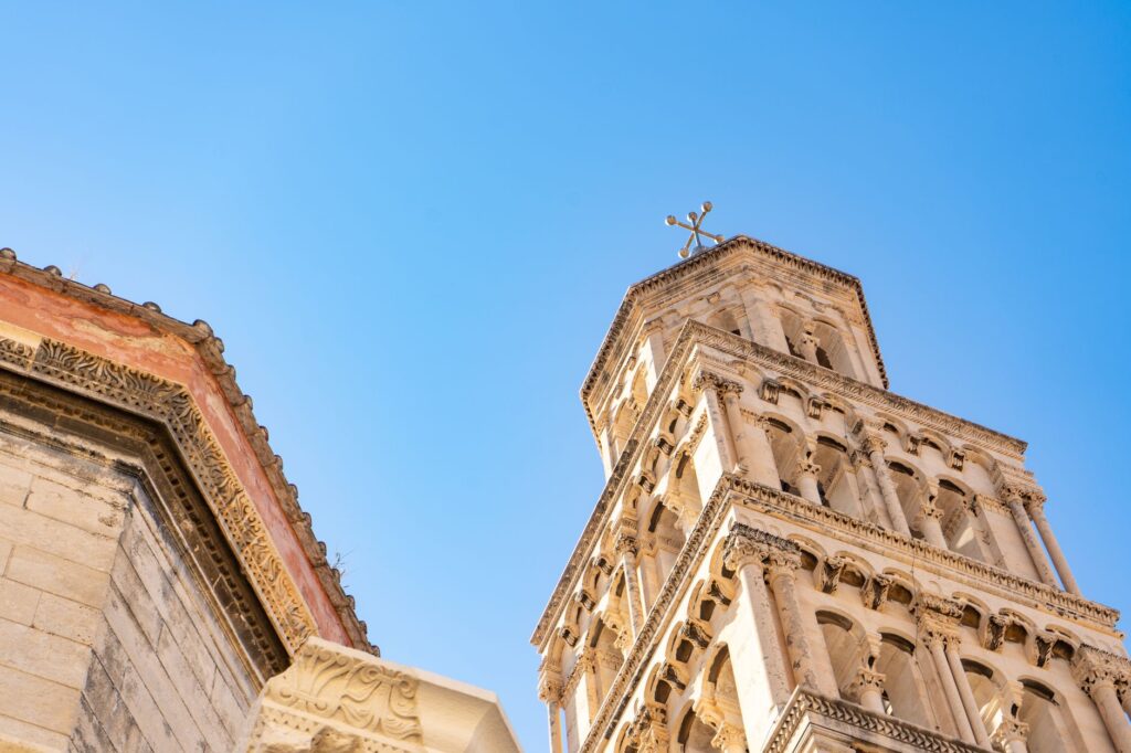 Split, Croatia — Detailed view of a historic tower in Split, Croatia against a clear blue sky.