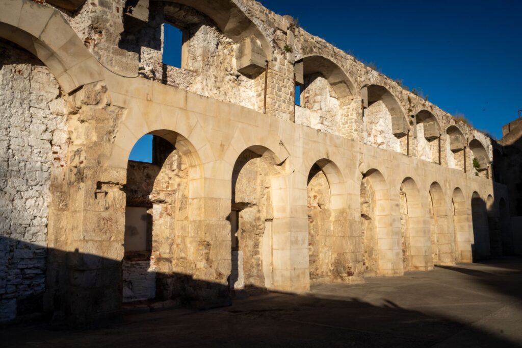 Split, Croatia — Sunlit Roman architectural ruins in Split, showcasing ancient arches and stonework.