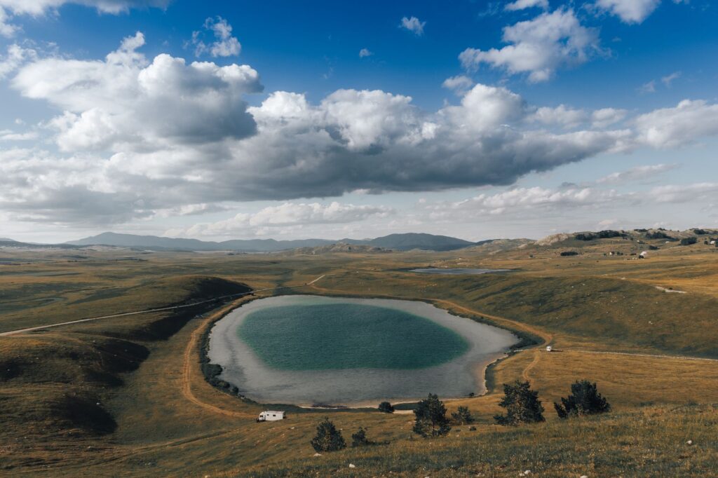 Zabljak, Montenegro — A breathtaking aerial view of a serene lake surrounded by mountains in Opština Žabljak, Montenegro.