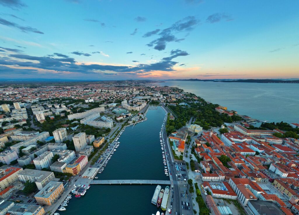 Zadar, Croatia — A breathtaking aerial shot of Zadar, Croatia, capturing the city's coastal beauty and vibrant skyline at sunset.