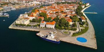 Zadar, Croatia — A stunning aerial view of Zadar's historic waterfront, showcasing the blend of urban architecture and scenic coastlines.