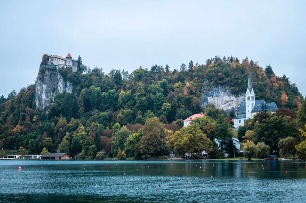 Bled, Slovenia — Picturesque view of Bled Castle and St. Martin's Church with lush greenery in Slovenia.