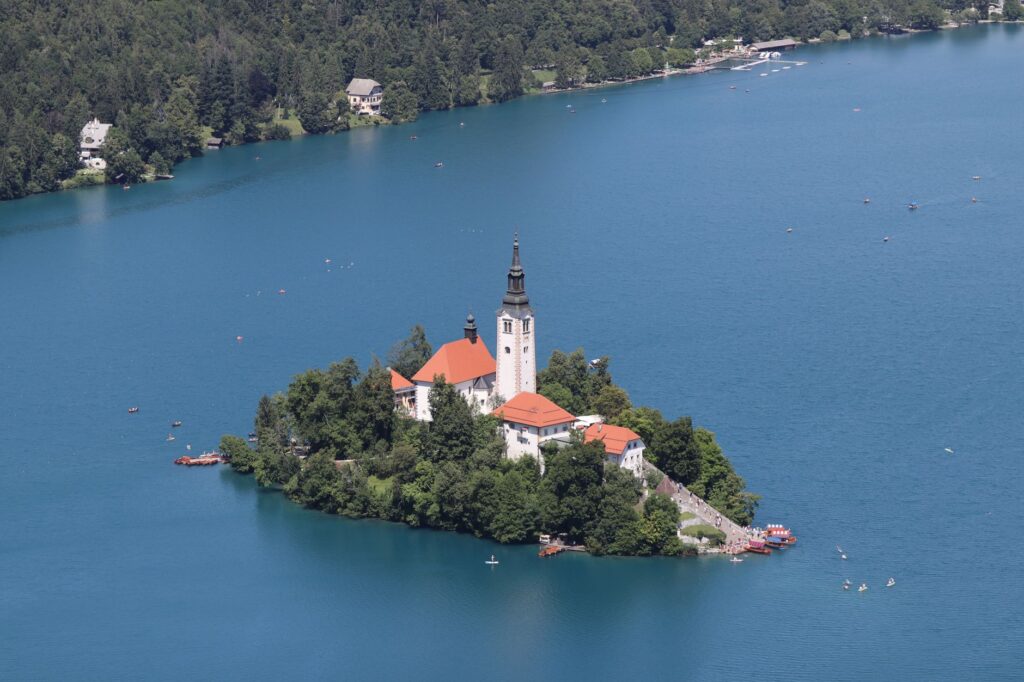Bled, Slovenia — Peaceful aerial view of Bled Island with its iconic church on Lake Bled, Slovenia, surrounded by blue waters.