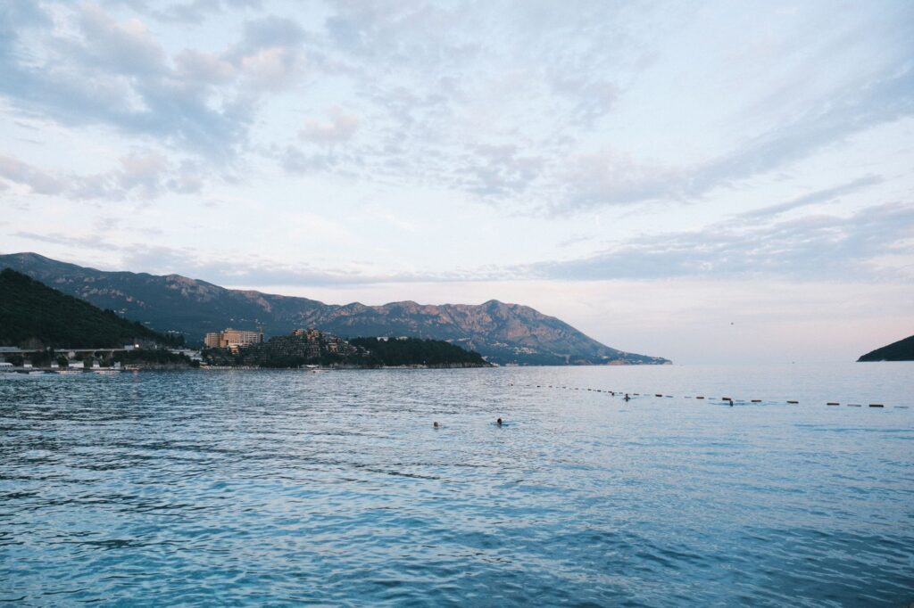 Budva, Montenegro — Tranquil Adriatic Sea view with distant mountains and serene water in Budva, Montenegro.