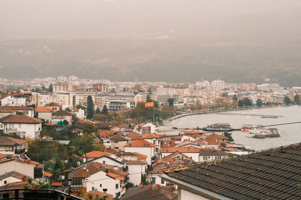 Ohrid, North Macedonia — Scenic aerial view of Ohrid city with Macedonian flag and Lake Ohrid in autumn.