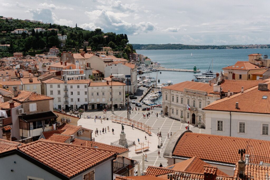 Piran, Slovenia — Aerial view of the coastal town Piran in Slovenia with red rooftops and the Adriatic Sea.