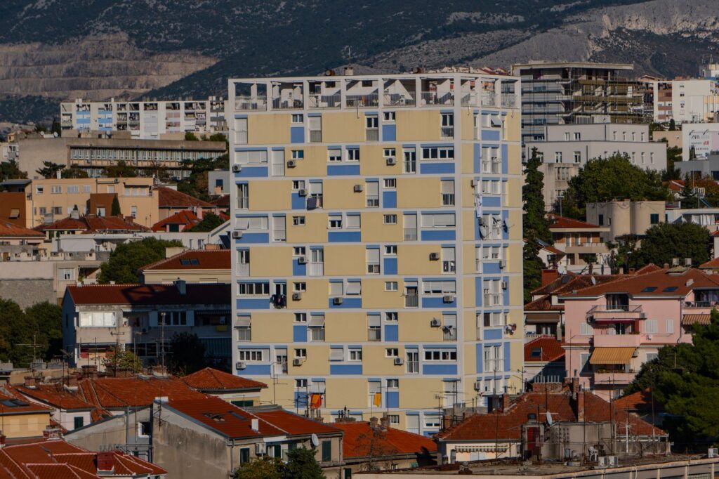 Split, Croatia — High-rise building amidst traditional rooftops in Split, Croatia's urban landscape.