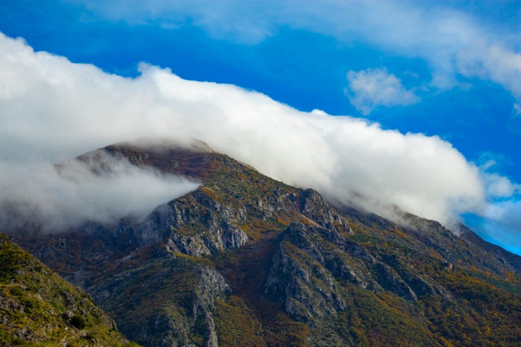 Bar, Montenegro — Majestic view of clouds draping over rugged mountains in Stari Bar, Montenegro, highlighting natural beauty.