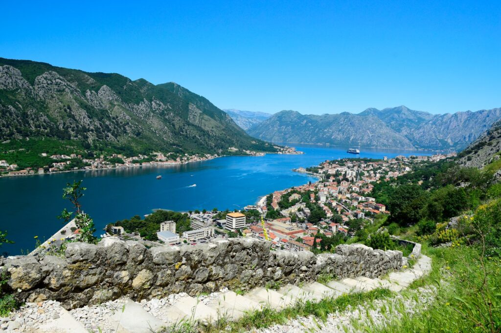 Kotor, Montenegro — A stunning aerial view of Kotor, Montenegro showcasing the bay, cruise ship, and mountains.