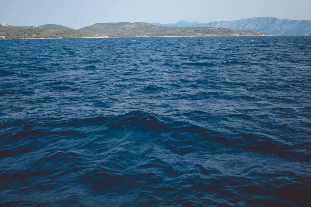 Makarska, Croatia — A peaceful seascape of the Adriatic Sea with distant Croatian mountains in Makarska.