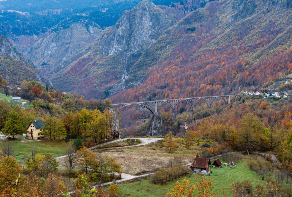Tara, Serbia — Scenic autumn landscape featuring Durdevica Tara Bridge amidst mountainous terrain in Montenegro.